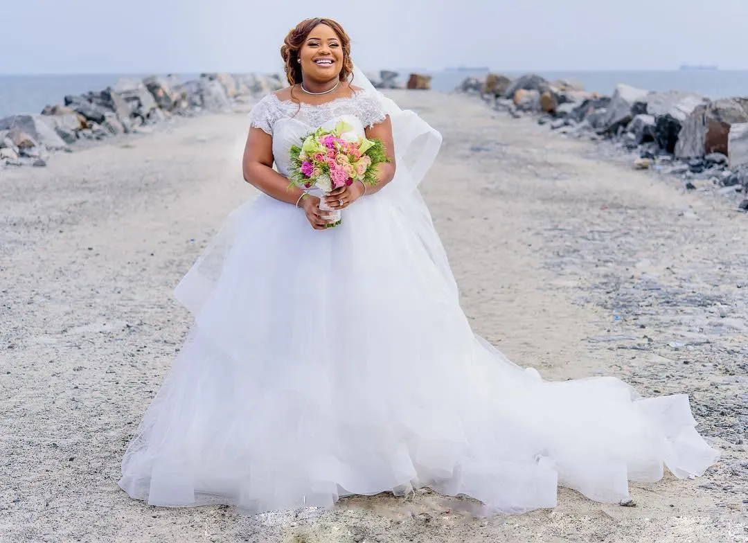 Gorgeous Plus Size Wedding Dresses 2018 Summer Lace Cap Sleeves A Line Beach Bridal Gowns With Pink Ribbon Sash Tulle Puffy Wedding Dresses